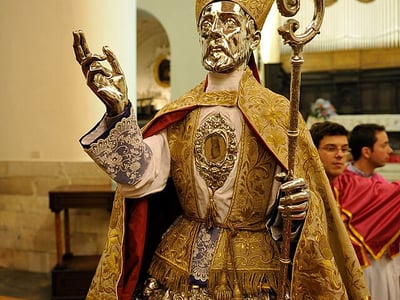 Silver statue of a saint, decorated with rich embroidery, presented during a celebration at the Cathedral of Bovino.