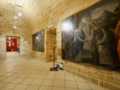 Corridor of the Diocesan Museum with 16th-century religious frescoes, illustrating captivating biblical scenes.