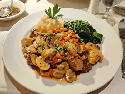 Delicious plate of mushrooms, carrots, and spinach, served with meat, at the restaurant La Masseria.
