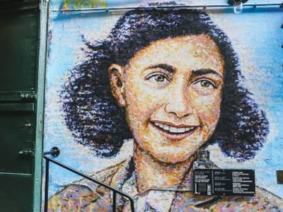 Mural depicting Anne Frank, located at Haus Schwarzenberg, a symbol of memory and human resilience.