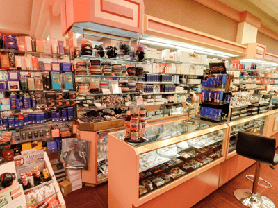 Rayons bien organisés de produits de beauté et de santé chez Zitomer Pharmacy, avec des vitrines illuminées et des étagères colorées.