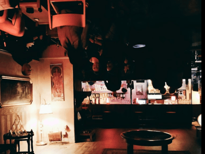 Warm atmosphere of Madame Claude, with customers gathered around a table in a vintage and intimate setting.