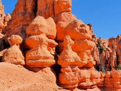 Impressive and colorful rock formations of Red Canyon, with a hiker for scale. Ideal for adventurers.