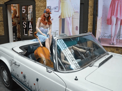 A magnificent display at Camden Market with mannequins in a car, creating a unique vintage atmosphere.