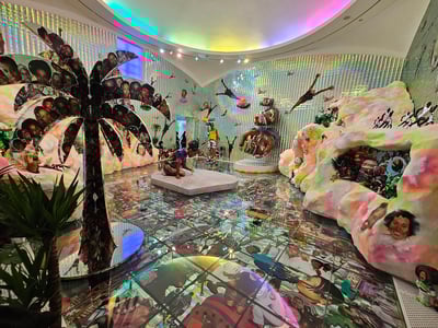 Colorful exhibition room at the Serpentine Gallery, featuring modern artworks and immersive elements.