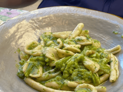 Fresh pasta with basil pesto, served on an elegant plate at Vino Fritti e Cucina, highlighting Italian cuisine.