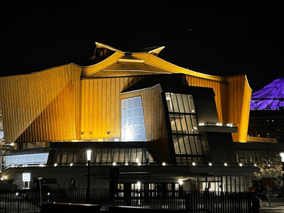 Iconic architecture of the Berlin Philharmonie illuminated at night, reflecting the musical and artistic creativity of the city.