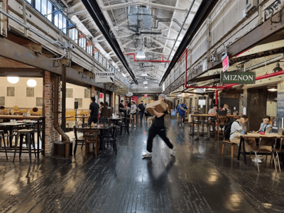 An animated view of Chelsea Market, showing visitors enjoying the atmosphere and food stalls.