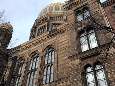 Detailed view of the Neue Synagogue in Berlin, showcasing its distinctive dome and historic brick architecture.