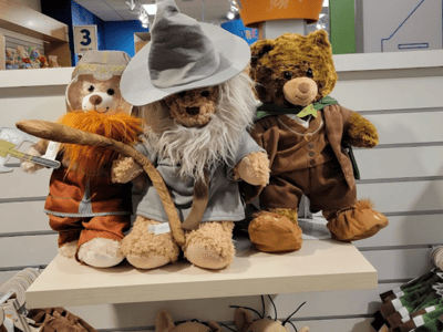 Three teddy bears dressed as fantastical characters, displayed in the Build-A-Bear Workshop store.