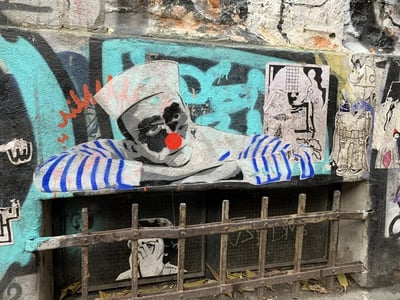 A stylized clown on a wall at Haus Schwarzenberg, illustrating Berlin's vibrant urban culture.