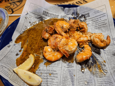 Spicy shrimp with sauce, served on old paper at Bubba Gump Shrimp Co., a delicious culinary experience.