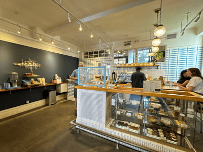 Interior of One Girl Cookies, showcasing a display filled with artisanal pastries and a welcoming café space.