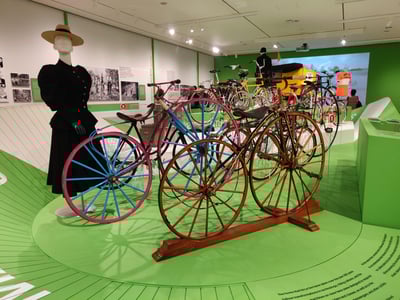 Exhibition of colorful historic bicycles at the Museum of the City of New York, illustrating the evolution of urban transportation.