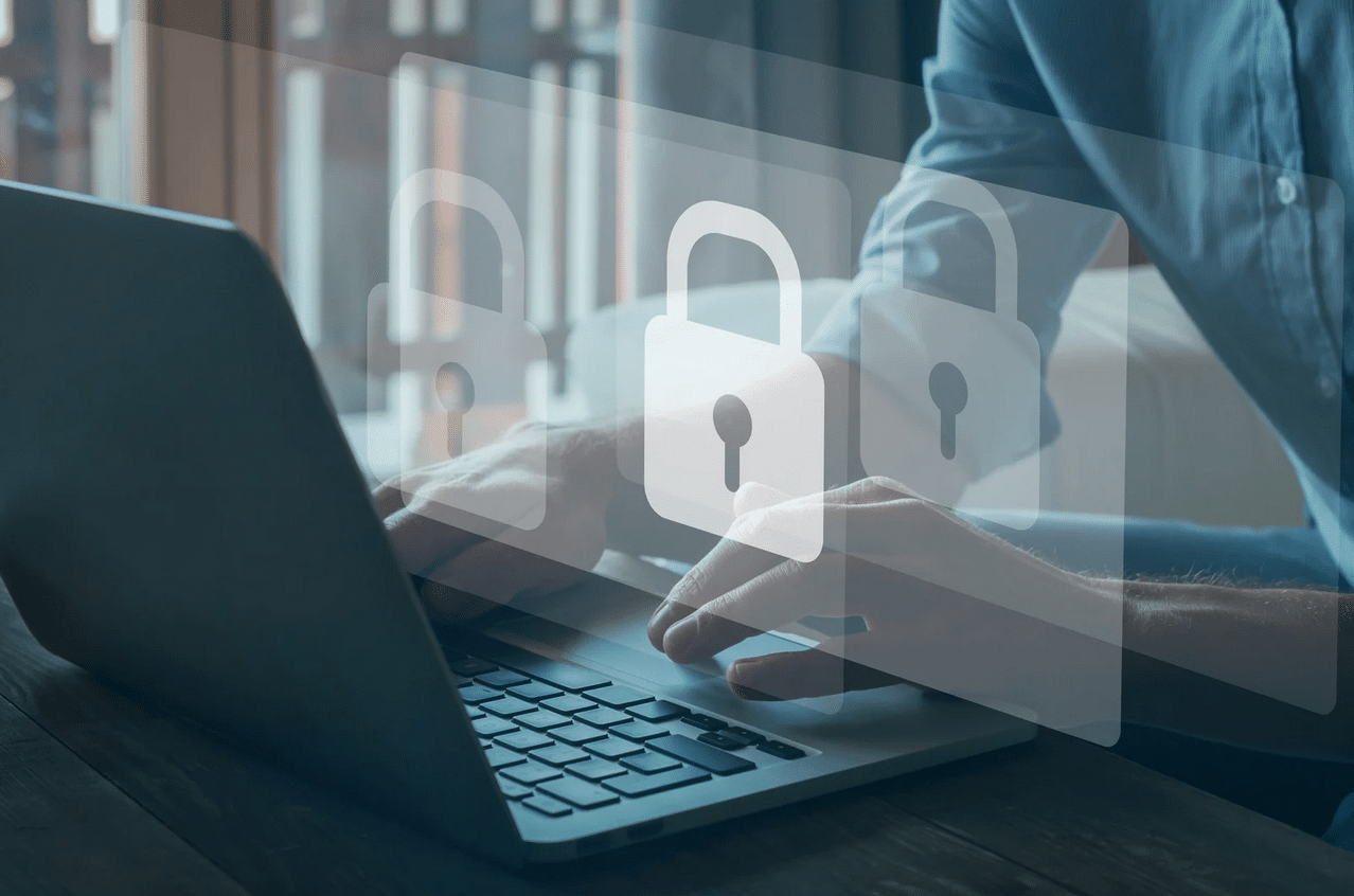 SSL-Cert Person typing on a laptop with transparent padlock icons overlayed, representing cybersecurity or data protection concepts.