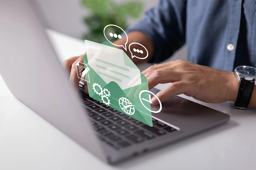 Access email using Webmail Image Person typing on a laptop with digital graphics of an open envelope and communication icons overlayed on the image.