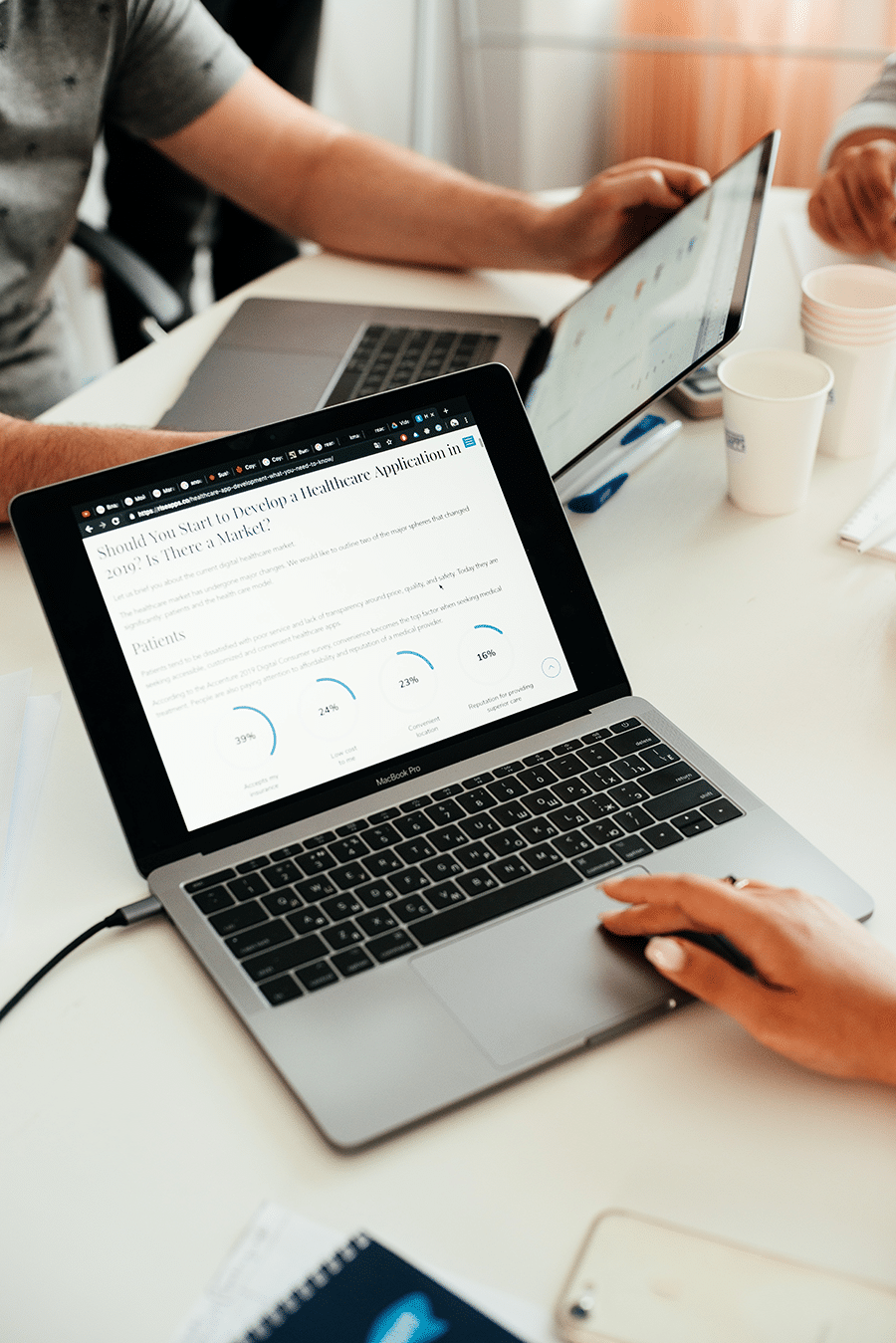 A group of people using Reseller Hosting with cPanel and WHM on a laptop.