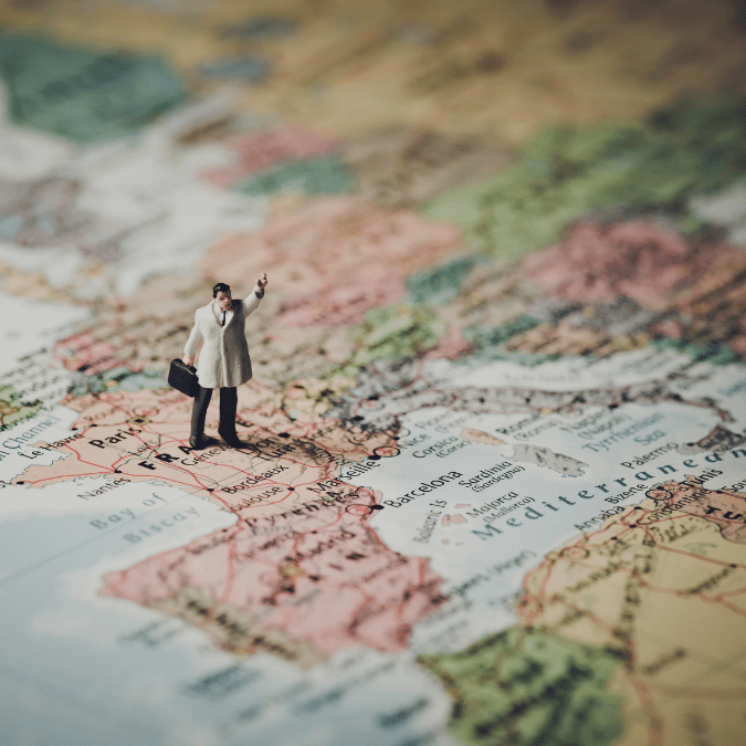 A map with various cities and bodies of water labeled in Europe. A business person is superimposed on the image