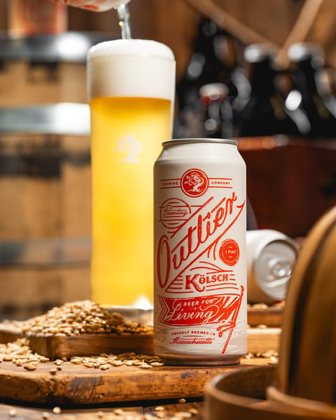 Outlier is our Kolsch, a crisp German Ale that carries notes of doughy malt, lemon peel, and earthy noble spice. It’s…