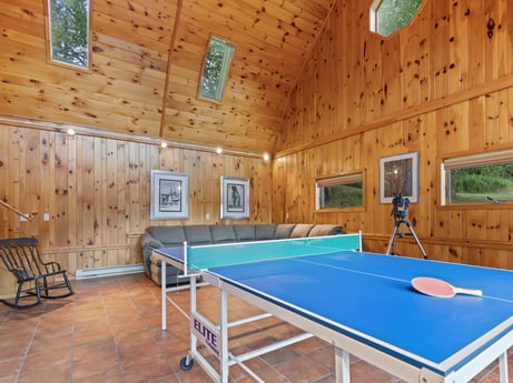An image featuring building, furniture, table tennis racket, window, table, wood, recreation room, interior design, house, floor at 130 Haighs Pond Rd.