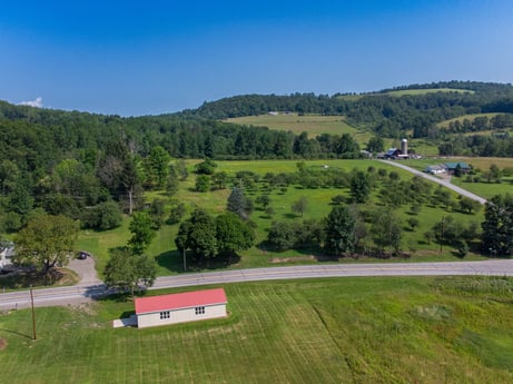An image featuring sky, plant, ecoregion, natural landscape, mountain, land lot, highland, tree, grass, grassland at 17899 US-6.