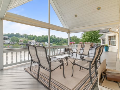 An image featuring sky, table, chair, shade, wood, porch, plant, interior design, floor, building at 218 Point Rd.