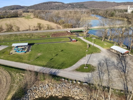 An image featuring water, plant, sky, tree, land lot, slope, natural landscape, grass, grassland, plain at River Access Rd.