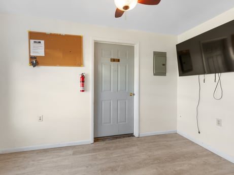 An image featuring door, fixture, wood, lighting, floor, dead bolt, flooring, building, home door, house at 302 N Keystone Ave.