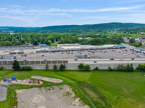 An image featuring sky, cloud, water resources, plant, infrastructure, land lot, grass, urban design, tree, landscape at 1040 Center St.