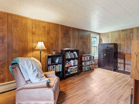 An image featuring furniture, comfort, wood, living room, interior design, flooring, floor, shelving, laminate flooring, shelf at 2399 Keene Summit Rd.