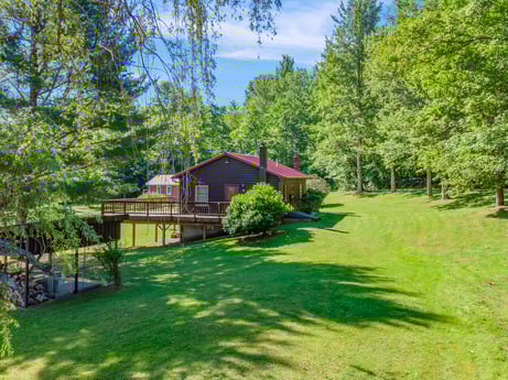 An image featuring plant, property, sky, tree, building, natural landscape, house, land lot, shade, cloud at 735 Midnight Ln.
