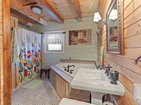An image featuring tap, property, furniture, sink, plumbing fixture, wood, interior design, mirror, bathtub, window at 1761 Brick House Rd.