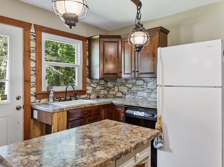 A kitchen at 145 Nichols Ln featuring: countertop, cabinetry, property, window, sink, kitchen sink, kitchen, tap, interior design, lighting