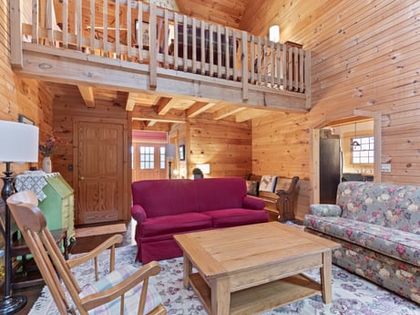 An image featuring furniture, property, couch, table, wood, interior design, living room, studio couch, floor, flooring at 1761 Brick House Rd.