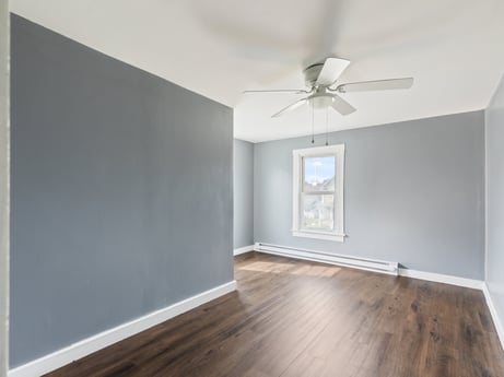 An image featuring property, ceiling fan, wood, building, interior design, architecture, shade, floor, wall, flooring at 203 Harrison St.