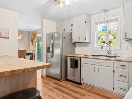 A kitchen at 491 Hillcrest Dr featuring: countertop, cabinetry, sink, wood, drawer, kitchen, interior design, picture frame, flooring, floor