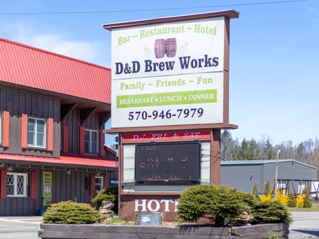 An image featuring plant, sky, building, window, billboard, real estate, facade, door, commercial building, city at 4741 US-220.