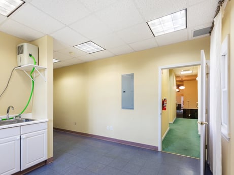 An image featuring property, fixture, lighting, interior design, building, flooring, floor, door, wall, cabinetry at 213 Main St.