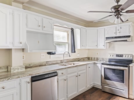 An image featuring cabinetry, countertop, property, ceiling fan, furniture, kitchen sink, white, sink, building, kitchen stove at 203 Harrison St.