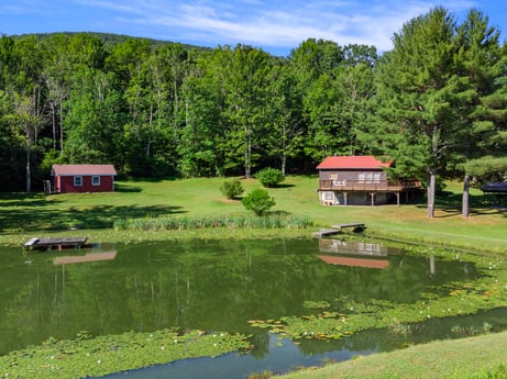 An image featuring water, cloud, sky, plant, water resources, nature, tree, natural landscape, house, lake at 735 Midnight Ln.