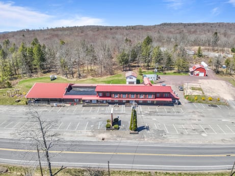 An image featuring plant, cloud, sky, train, vehicle, tree, rolling stock, asphalt, track, mode of transport at 4741 US-220.