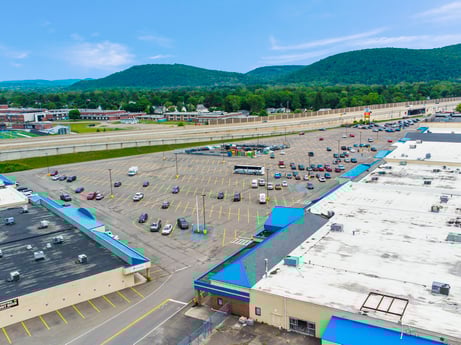 An image featuring sky, cloud, vehicle, blue, transport hub, asphalt, urban design, air travel, tree, mountain at 1040 Center St.