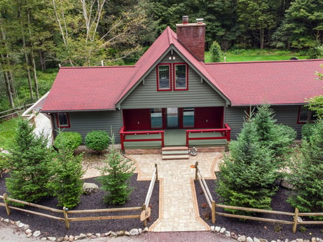 An image featuring plant, building, window, tree, house, wood, cottage, land lot, door, siding at 276 Mountain View Ln.