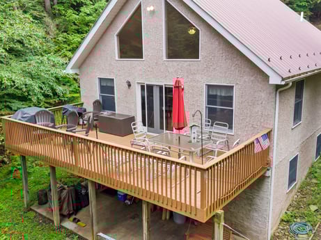 An image featuring building, window, property, wood, porch, cottage, house, grass, tree, siding at 459 Pine Hill Dr.