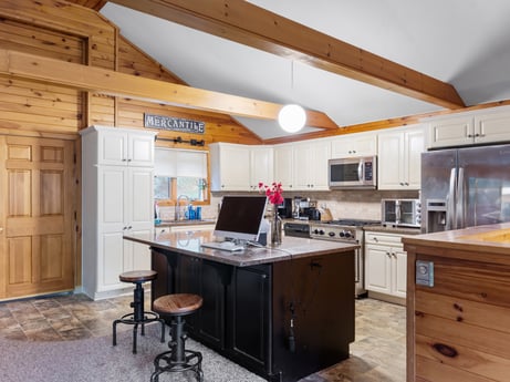 An image featuring building, cabinetry, furniture, computer, property, table, personal computer, chair, computer monitor, computer desk at 125 Marcy Rd.