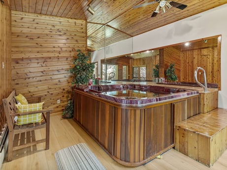 A kitchen at 104 Stony Mountain Rd featuring: furniture, cabinetry, countertop, tap, wood, ceiling fan, kitchen, interior design, floor, flooring
