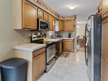 A kitchen at 1841 Lynch Rd featuring: countertop, cabinetry, kitchen, kitchen appliance, home appliance, kitchen stove, wood, lighting, interior design, sink