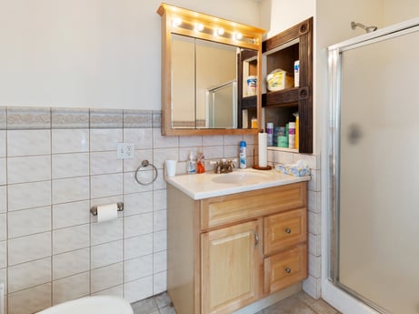 An image featuring mirror, bathroom cabinet, tap, cabinetry, building, property, sink, furniture, plumbing fixture, bathroom sink at 213 Main St.