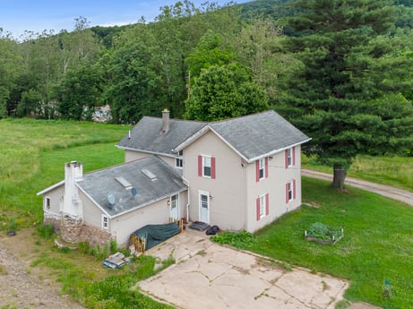 An image featuring plant, property, building, sky, window, tree, house, land lot, cottage, grass at 709 Creek Rd.