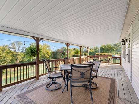 An image featuring furniture, table, plant, wood, porch, shade, interior design, chair, floor, tree at 62 Leons Rd.